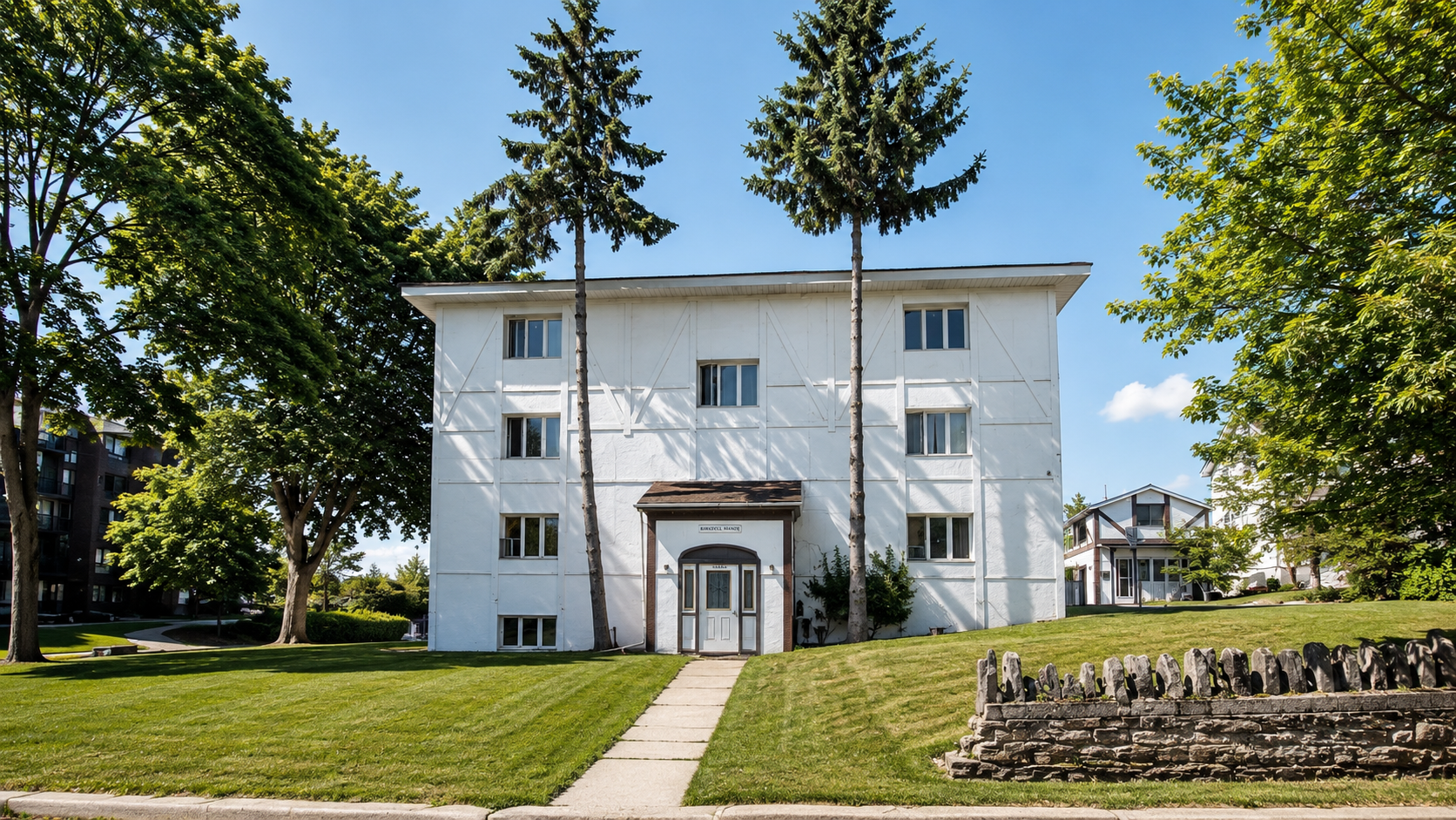White residential apartment building managed by CLC Properties